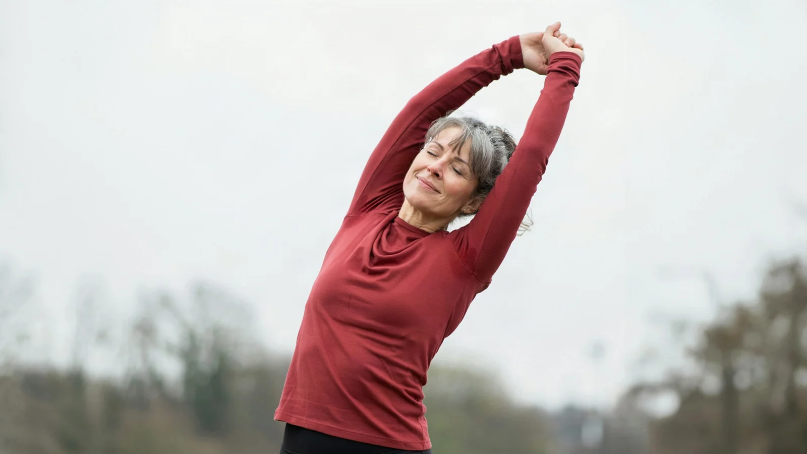 A woman stretching her arms in the open air